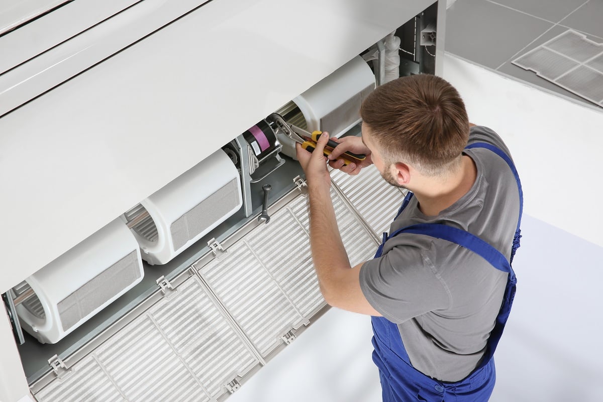 ac technician repairing unit